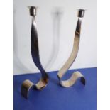 A pair of very stylish modern designer Italian silver-plated table candlesticks of curved and