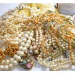 Assorted simulated pearl necklaces and bracelets, a pair of ear clips and a box of buttons, and