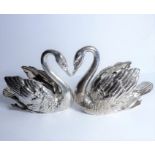An unusual pair of mid-20th century hallmarked heavy silver table centres modelled as swans; each