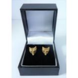 An unusual pair of 9-carat gold earrings, each modelled as a fox mask with ruby eyes (The cost of UK