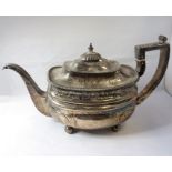A late George II period hallmarked silver teapot; profusely engraved with flower heads and