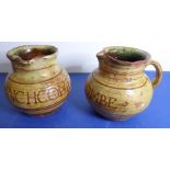 A pair of early Winchcombe Pottery slipware jugs; incised in capitals 'WINCHCOMBE', attributed to