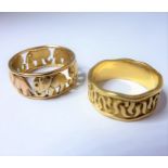 Two wide band rings: the first with wavy edges and applied with 'S' motifs, 18-carat yellow gold,