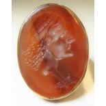A neoclassical intaglio hardstone ring; the oval chalcedony plaque deeply engraved to depict a