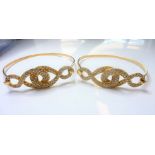 A pair of gold and diamond-set bangles, each top section of entrelac design, closed-set with