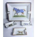 An Hermés of Paris ashtray decorated with a striding horse together with three smaller porcelain