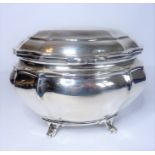 A Victorian silver bombe-shaped tea caddy standing on scroll feet, Goldsmiths of Regent Street,