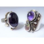Two late 20th century silver and gem-set dress rings: the first set with an oval cabochon amethyst