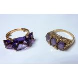 Two amethyst-set rings: the first comprising three cushion-shaped fancy-cut amethysts to the