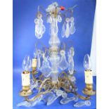 An early 19th century chandelier with shaped cut-glass droppers, probably French, now converted to