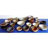 A collection of studio stoneware from various potteries: mostly bowls, but also six porringers and