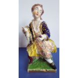A circa 1775 Derby porcelain figure; a boy in period dress sitting on a chair and holding a cat