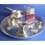 An assortment of small silver: to include two napkin rings, a small (weighted) table candlestick (