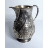 A small hallmarked silver jug with sparrow-beak-style spout; probably 18th century, later repoussé