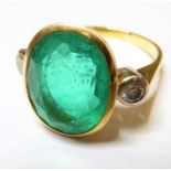 An emerald, diamond-set and 18-carat gold ring, the central oval mixed-cut emerald measuring 15mm