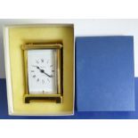 A mid-20th century gilt-metal and bevelled-glass carriage clock; white dial with Roman numerals,