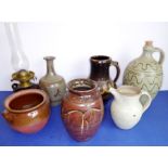 A collection of seven pieces of studio stoneware: to include a Cricklade vase with handle, an oil