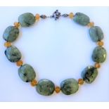A faceted green-stone and citrine-bead necklace, the ten shaped rectangular faceted beads with black
