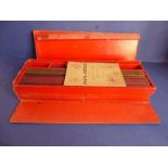 A boxed Mah Jong set; complete with four trays, each containing 36 tiles, and instructional booklet,