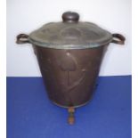 A two-handled circular coal bucket with lid; decorated in repoussé-style with Art Nouveau-style