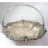A hallmarked silver 19th century cake basket with swing handle; the pierced border heavily cast with