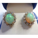 A pair of oval cabochon opal and brilliant-cut diamond cluster earrings, 18-carat yellow gold closed
