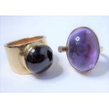 A Danish 1980s amethyst oval cabochon ring with a diamond-set collet to one side, the yellow-gold