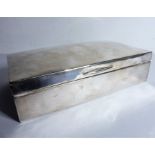 A rectangular hallmarked silver cigarette box; cedar lining, Birmingham assay marks, probably