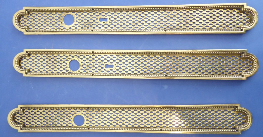 Three late 19th/early 20th century brass doorplates; each with handle apertures and two with lock