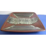 A press-moulded square dish by Don Jones; unmarked and with glaze trail decoration in the manner