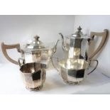 A four-piece hallmarked silver tea and coffee service comprising coffee pot, teapot, two-handled