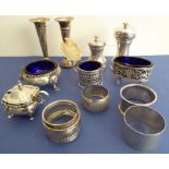 A selection of small table silverware; to include four napkin rings, salt and pepper grinders and