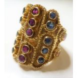 A gem-set dress ring; the wide shaped shield applied with rope-twist decorations and with