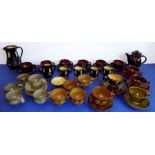 Assorted post-war tea and coffee cups in slipware and stoneware; some with matching plates and jugs,