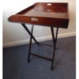 A 19th century three-handled mahogany butler's tray on stand; the folding x-frame stand with two