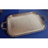A large and heavy two-handled silver-plated rectangular serving tray; the two highly decorative cast