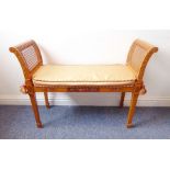 A good Sheraton revival satinwood window seat, painted floral and swag decoration and with rattan