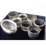 Hallmarked silver comprising seven napkin rings and a small boat-shaped silver salt (total weight