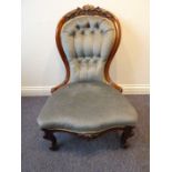 A mid-19th century mahogany show-wood framed and button-back upholstered nursing chair; raised on