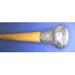 A late 19th century turned wood walking cane having hallmarked silver handle decorated in repoussé