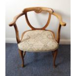 An unusual early 20th century walnut desk chair; the top rail with a scallop shell-style motif above