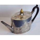 An oval hallmarked silver George III period teapot of oval section; pear-shaped ivory finial, carved