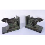 A pair of heavy verdigrised bronze bookends modelled as figures restraining Shire horses; each on