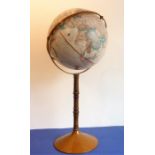 A large globe on a turned stainwood stand