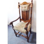 An early-style reproduction oak panel-back open armchair; the stuffover seat decorated with