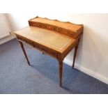 A reproduction yew-wood writing desk; the galleried superstructure with three concave drawers headed