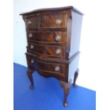 A reproduction serpentine-fronted mahogany chest on stand; crossbanded top above and an