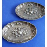 A pair of hallmarked silver (marked 925) oval trinket dishes; centrally decorated in high relief