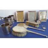 A three-piece hallmarked silver-backed hand-held Art Deco-style mirror and brush set, together