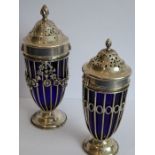 A matched pair of graduated hallmarked silver casters; of Neo-Classical form with floral swags,